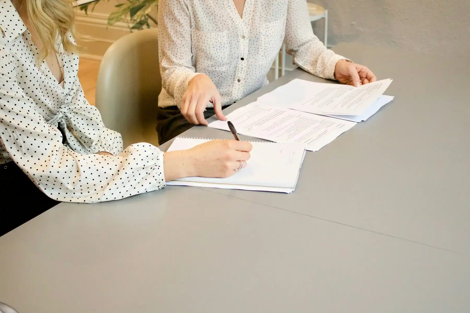 Two women reviewing written records together