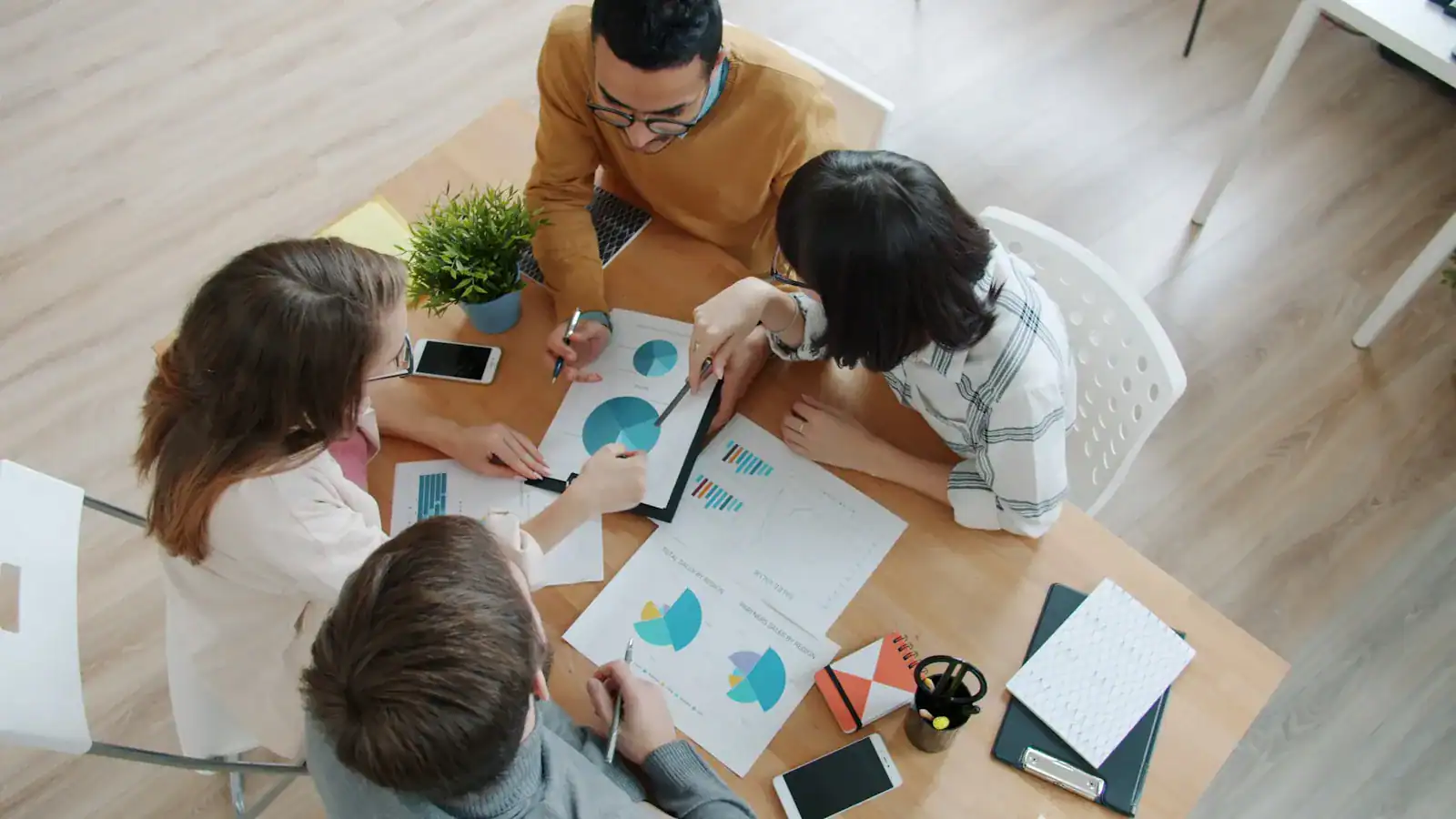 People sharing ideas and planning around a table